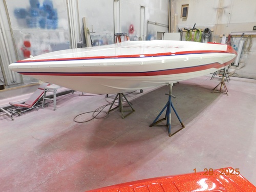 A restored fiberglass runabout at a Northern Michigan boatyard